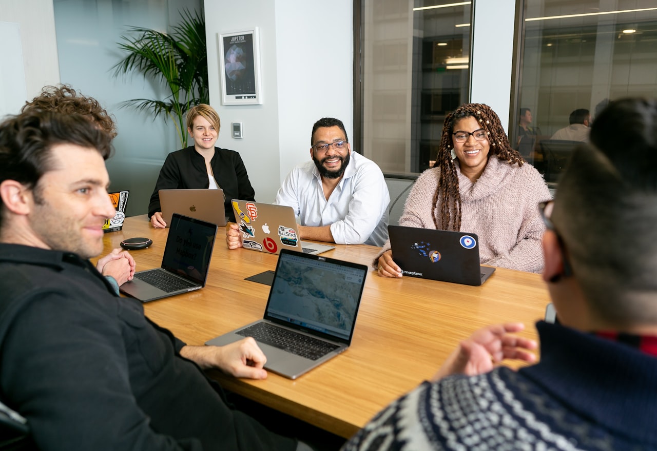 Waygrid leadership team meeting around a table in the office