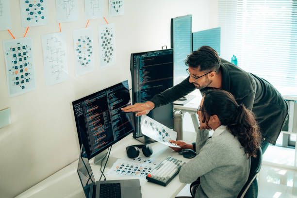 Program managers reviewing a portfolio roadmap on a large screen