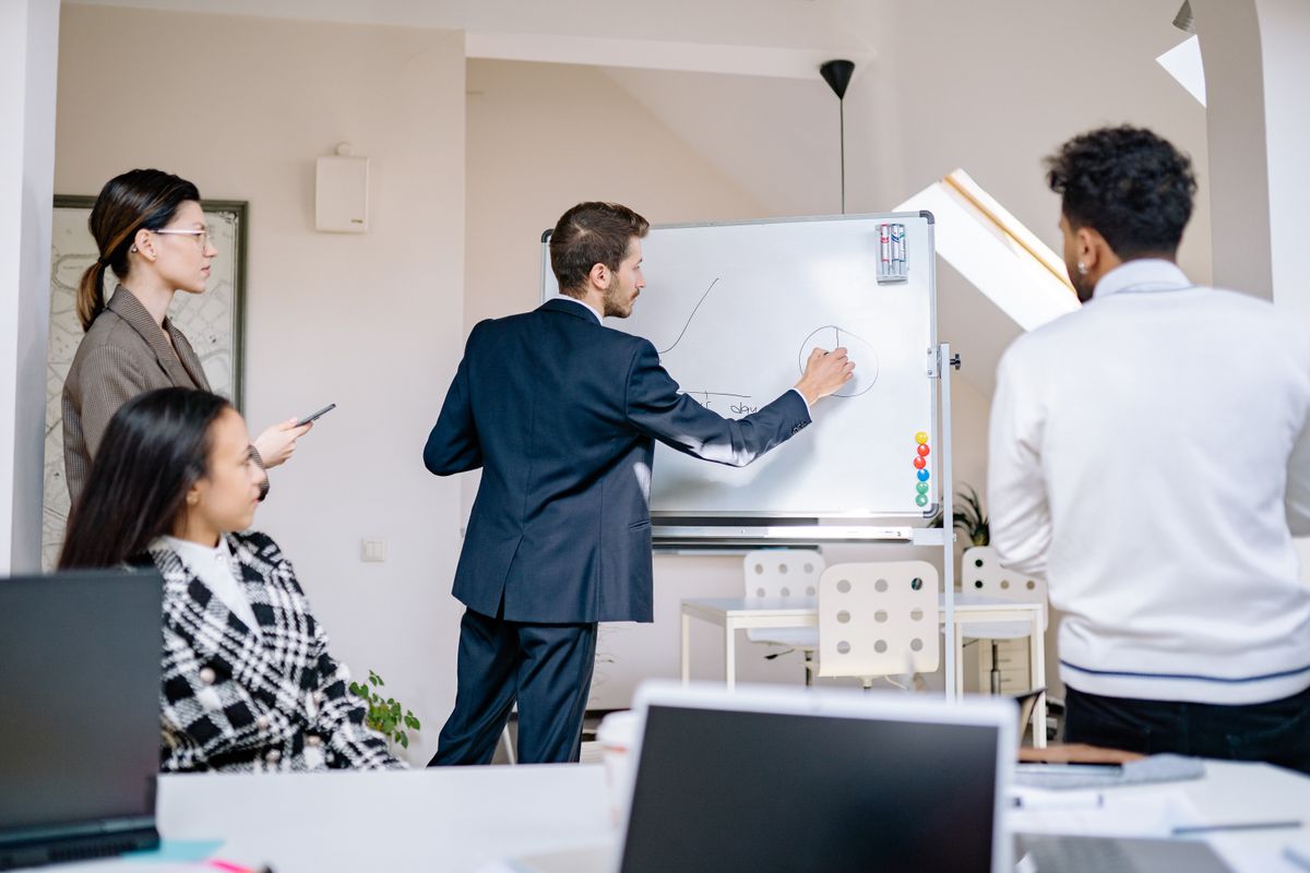 Engineers sketching service boundaries at a whiteboard