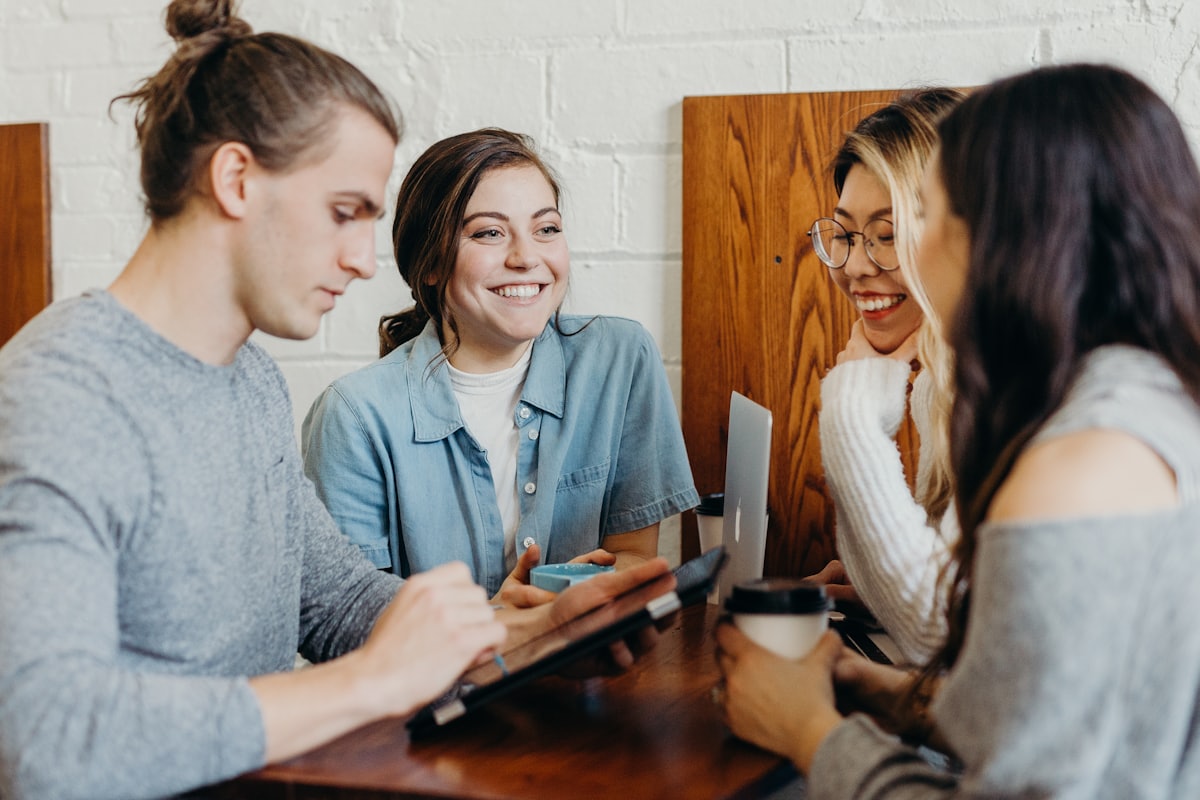 Waygrid coworkers laughing together over coffee